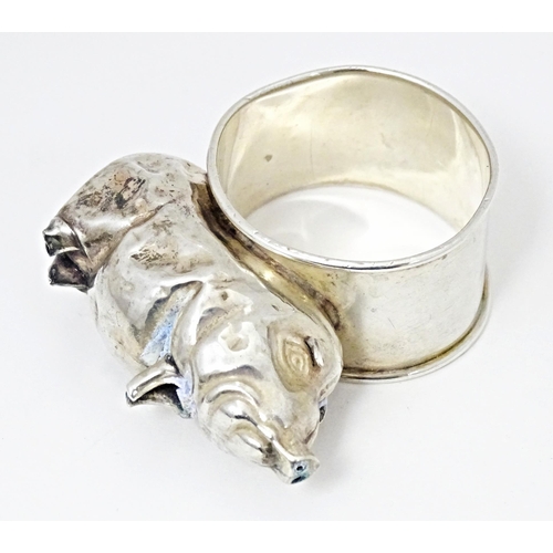 418 - A silver napkin ring mounted on a model of a pig, hallmarked Chester 1924, maker William Vale & Sons... 