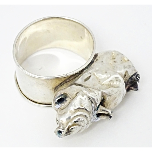 418 - A silver napkin ring mounted on a model of a pig, hallmarked Chester 1924, maker William Vale & Sons... 