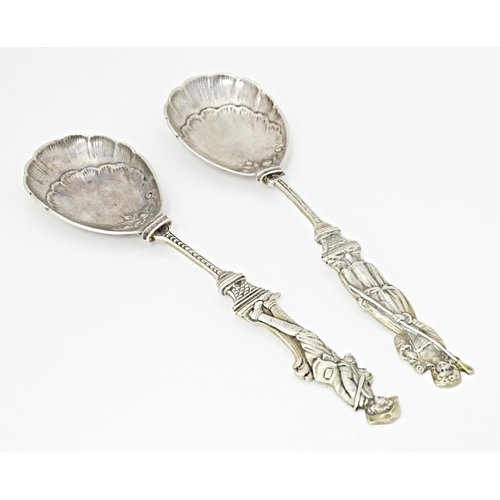 486 - Two Continental white metal serving spoons with figural detail to handles Indistinctly marked. 7 1/2... 