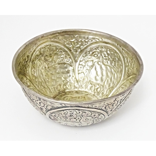 489 - A white metal bowl with embossed animal decoration. Possibly Indian / Persian. Approx 5