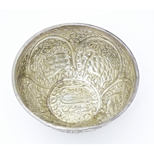 489 - A white metal bowl with embossed animal decoration. Possibly Indian / Persian. Approx 5