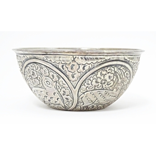 489 - A white metal bowl with embossed animal decoration. Possibly Indian / Persian. Approx 5