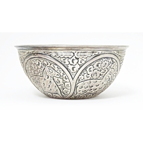 489 - A white metal bowl with embossed animal decoration. Possibly Indian / Persian. Approx 5