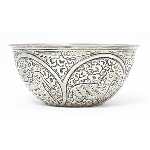 489 - A white metal bowl with embossed animal decoration. Possibly Indian / Persian. Approx 5