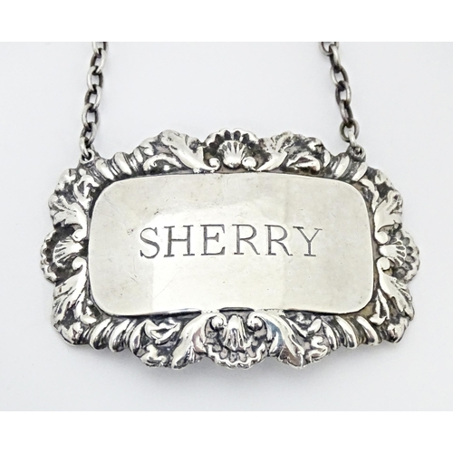 492 - A matched pair of silver 'Sherry' decanter labels. Hallmarked Birmingham  1958 / 1963 Ph Vogel & Co