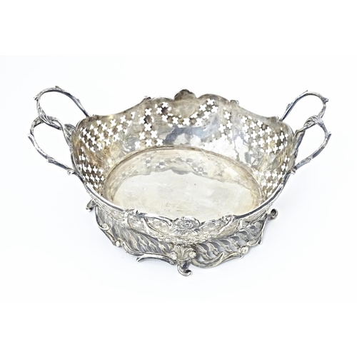 394 - A Victorian Continental silver bowl of basket form with twin handles and import marks for London 189... 