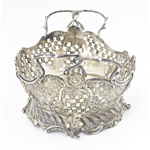 394 - A Victorian Continental silver bowl of basket form with twin handles and import marks for London 189... 