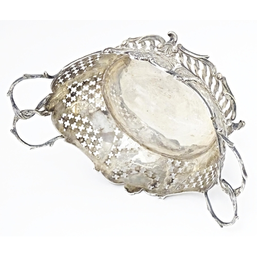 394 - A Victorian Continental silver bowl of basket form with twin handles and import marks for London 189... 