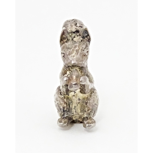 395 - A miniature silver model of a seated squirrel with a nut, hallmarked London 1976. Approx. 1