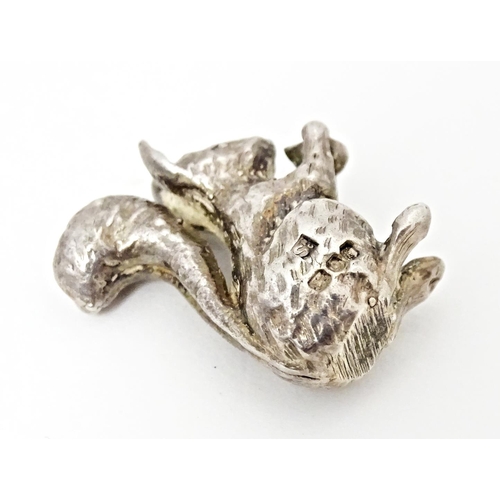 395 - A miniature silver model of a seated squirrel with a nut, hallmarked London 1976. Approx. 1