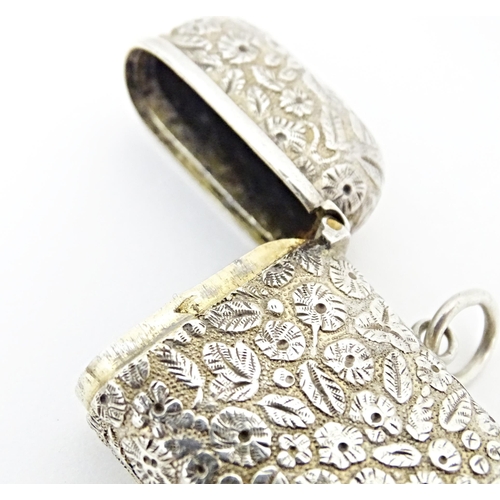 399 - A Continental silver vesta case with floral and foliate decoration. Approx. 2