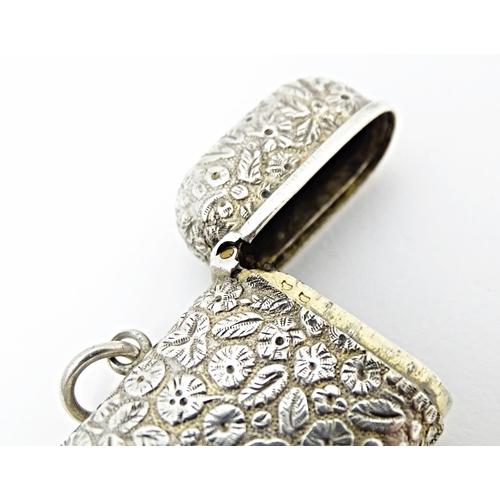 399 - A Continental silver vesta case with floral and foliate decoration. Approx. 2