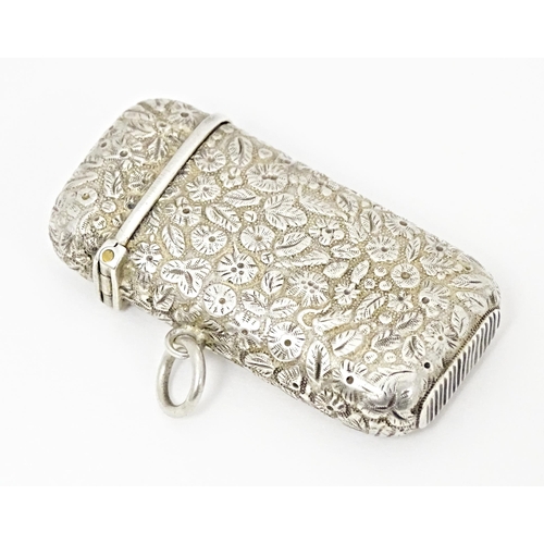 399 - A Continental silver vesta case with floral and foliate decoration. Approx. 2