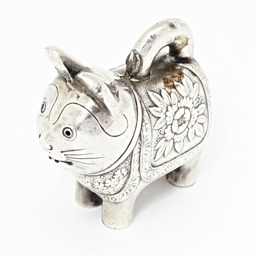 493 - An Oriental white metal novelty pepperette formed as a feline / cat /  neko. Marked with character m... 