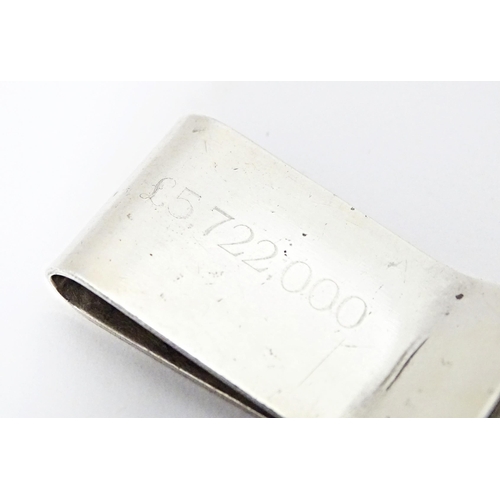 494 - A hallmarked silver money clip engraved '£5,722,000', assayed in Birmingham with Makers mark AR. App... 