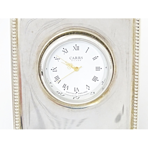 495 - An easel back clock with silver surround, hallmarked Sheffield 2007, maker Carrs of Sheffield Ltd. A... 