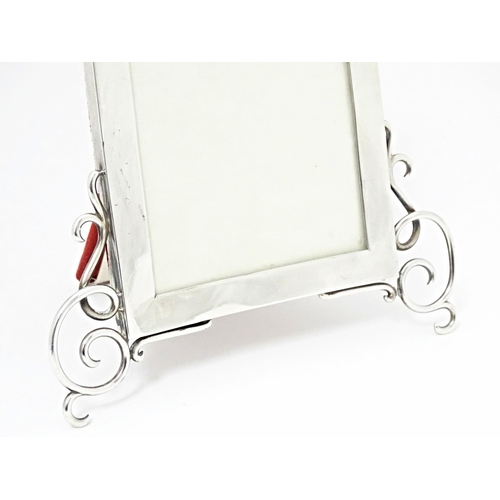 500 - A Victorian easel back photograph frame with silver surround hallmarked London 1899, maker Goldsmith... 