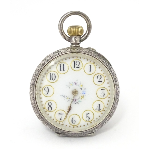 771 - A Continental .935 silver ladies fob watch, the white enamel dial with floral detail. Approx. 1 1/2