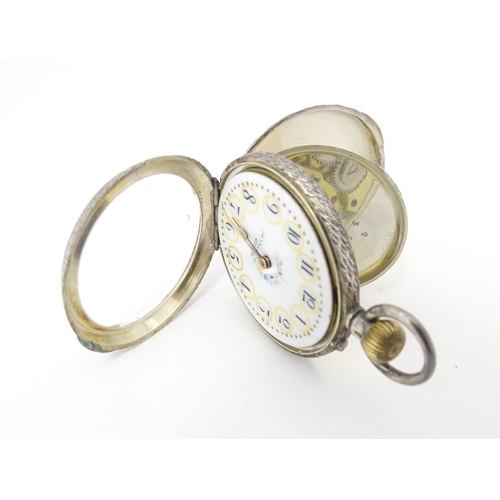 771 - A Continental .935 silver ladies fob watch, the white enamel dial with floral detail. Approx. 1 1/2