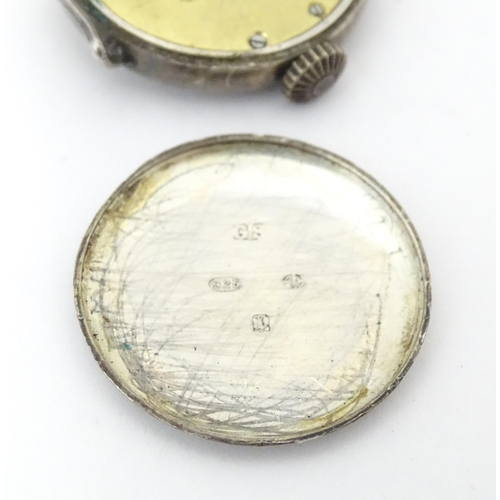 785 - A silver cased wrist watch movement with enamel dial. Approx. 1