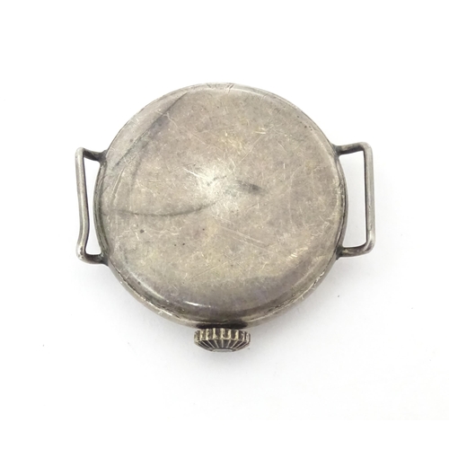 785 - A silver cased wrist watch movement with enamel dial. Approx. 1