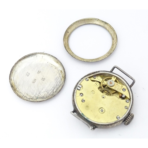 785 - A silver cased wrist watch movement with enamel dial. Approx. 1