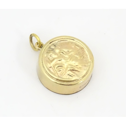 791 - A 9ct gold pendant / charm with St Christopher to one side and inset miniature compass to other. App... 