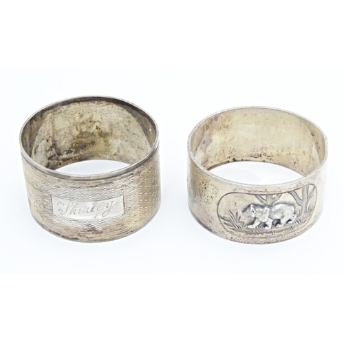 312 - Two silver napkin rings, one decorated with relief detail depicting a bear in a landscape, hallmarke... 