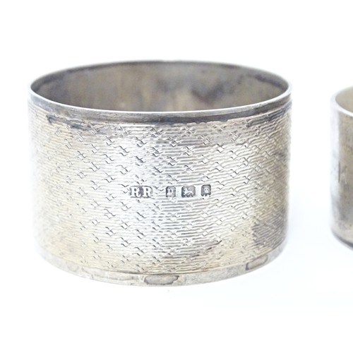 312 - Two silver napkin rings, one decorated with relief detail depicting a bear in a landscape, hallmarke... 