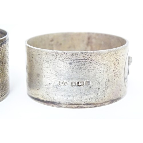 312 - Two silver napkin rings, one decorated with relief detail depicting a bear in a landscape, hallmarke... 