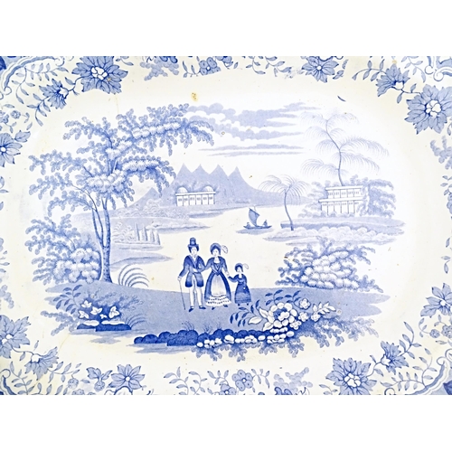 146 - A Victorian blue and white meat plate decorated in the Eton College pattern. Together with a brown a... 