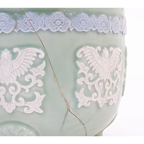 51A - A Chinese jardiniere / planter standing on three feet with celadon style ground and banded bird and ... 