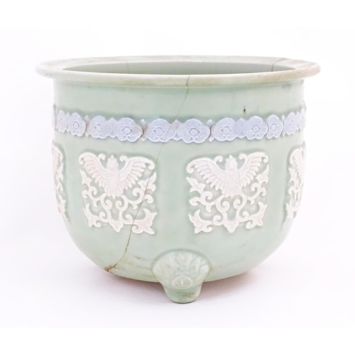 51A - A Chinese jardiniere / planter standing on three feet with celadon style ground and banded bird and ... 