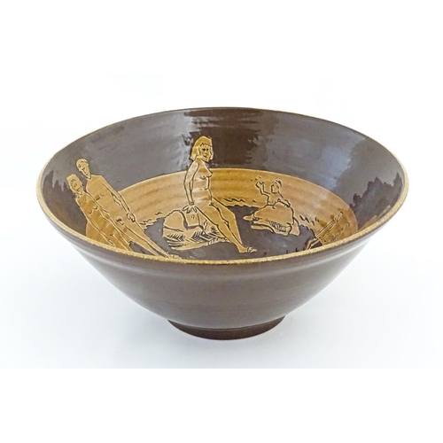 82 - A studio pottery bowl by Frank Haynes with sgraffito decoration depicting naturist / nude figures on... 