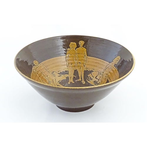 82 - A studio pottery bowl by Frank Haynes with sgraffito decoration depicting naturist / nude figures on... 