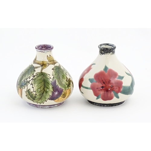 83 - Two Cobridge Pottery squat vases, one decorated with fruit, the other with flowers. Marked under. Ap... 