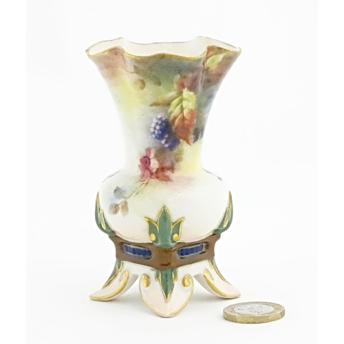 109 - A Hadley's Worcester bud vase with lobed rim and four out swept feet, decorated with flowers, fruit ... 