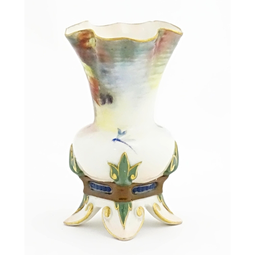 109 - A Hadley's Worcester bud vase with lobed rim and four out swept feet, decorated with flowers, fruit ... 