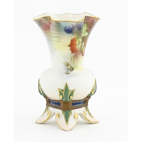 109 - A Hadley's Worcester bud vase with lobed rim and four out swept feet, decorated with flowers, fruit ... 