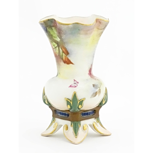 109 - A Hadley's Worcester bud vase with lobed rim and four out swept feet, decorated with flowers, fruit ... 