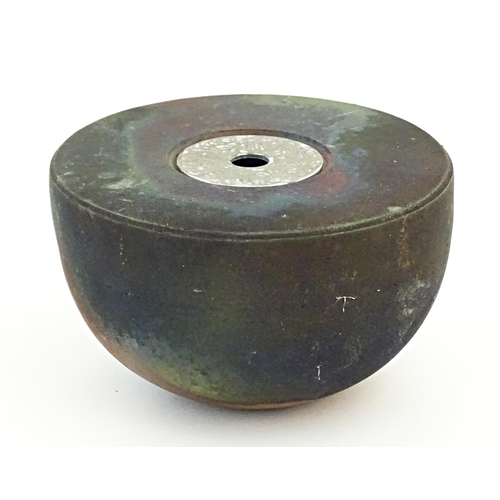 89 - A studio pottery raku pot with flat top by Andrew Niblett. Incised maker's mark under. Approx. 2 1/2... 