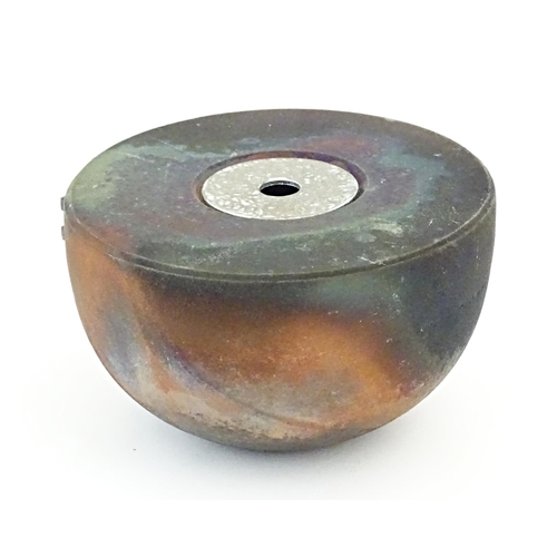 89 - A studio pottery raku pot with flat top by Andrew Niblett. Incised maker's mark under. Approx. 2 1/2... 