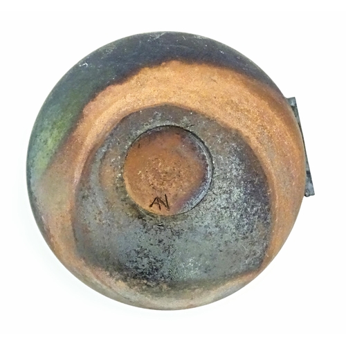 89 - A studio pottery raku pot with flat top by Andrew Niblett. Incised maker's mark under. Approx. 2 1/2... 