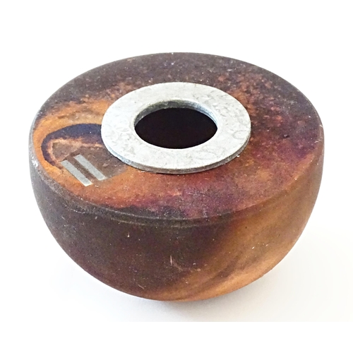 90 - A studio pottery raku pot with flat top by Andrew Niblett. Incised maker's mark under. Approx. 2 1/4... 