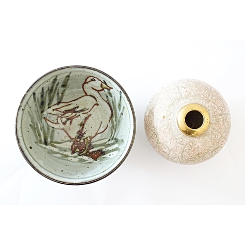 93 - A studio pottery bowl decorated with a duck amongst reeds, with impressed maker's mark to foot. Toge... 