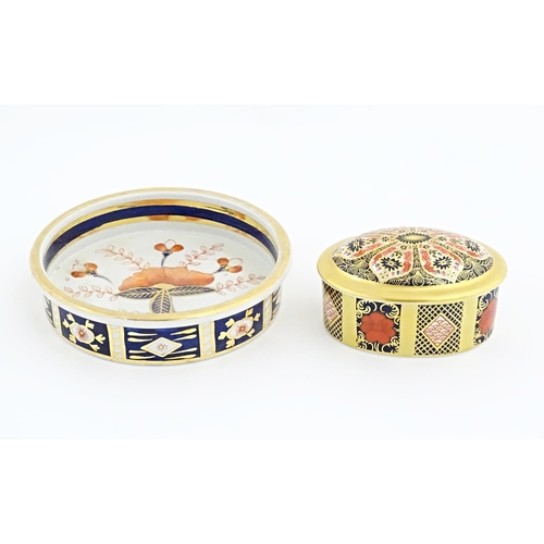 115 - Two items of Royal Crown Derby in the Old Imari pattern comprising pot and cover, and a small plate.... 