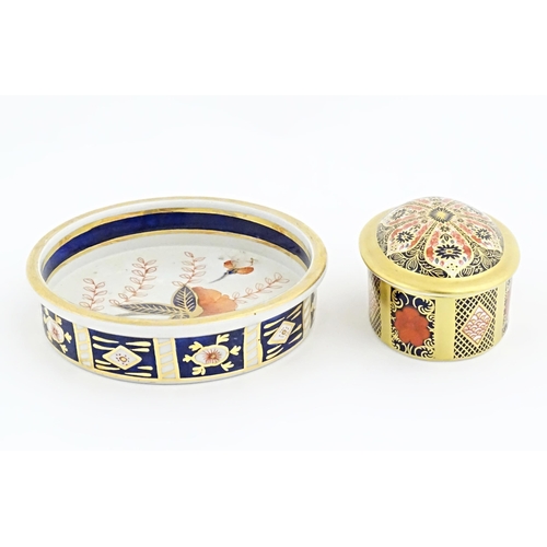 115 - Two items of Royal Crown Derby in the Old Imari pattern comprising pot and cover, and a small plate.... 