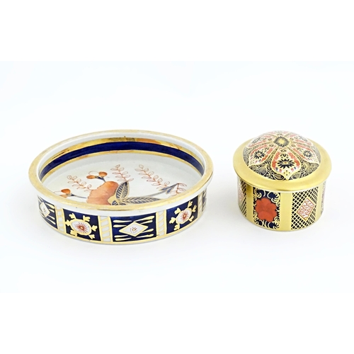 115 - Two items of Royal Crown Derby in the Old Imari pattern comprising pot and cover, and a small plate.... 