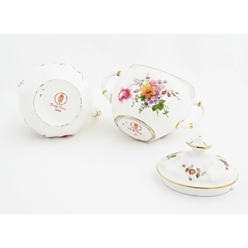 118 - A quantity of Royal Crown Derby tea wares in the Derby Posies pattern to include milk jug, twin hand... 