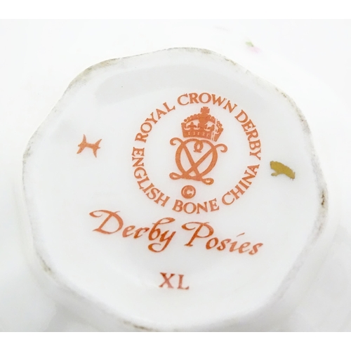 118 - A quantity of Royal Crown Derby tea wares in the Derby Posies pattern to include milk jug, twin hand... 